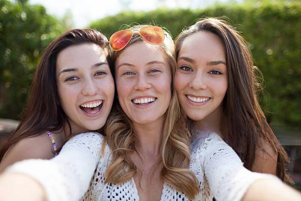 Two emotional female friends in jeans jackets posing while making selfie in  city cafe Stock Photo - Alamy