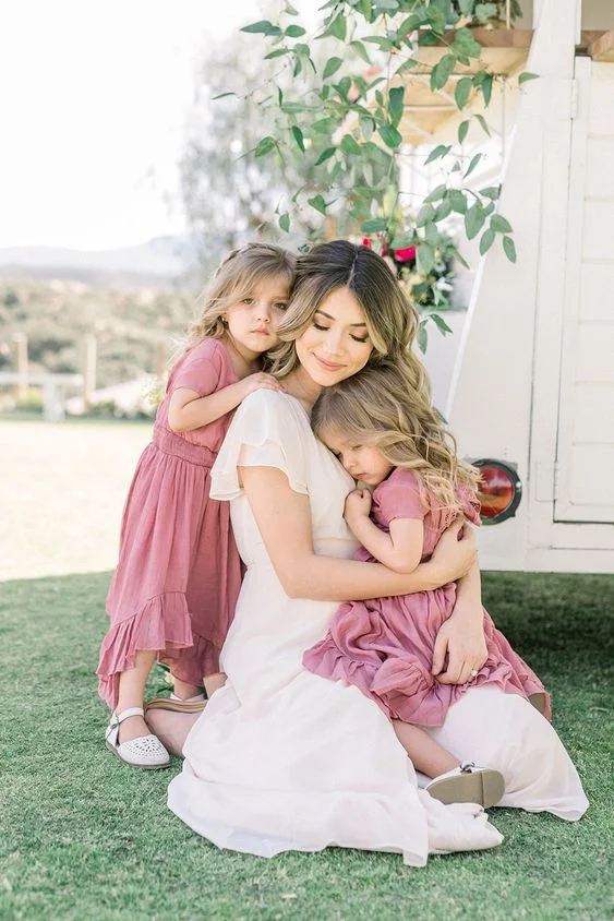 Posing with 2 babies on the backyard