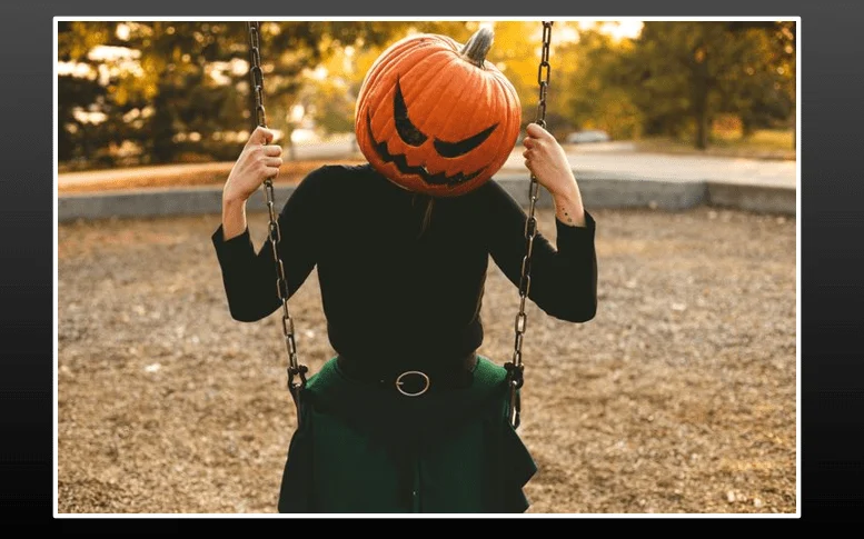 Pumpkin Head Swinging on a Swing