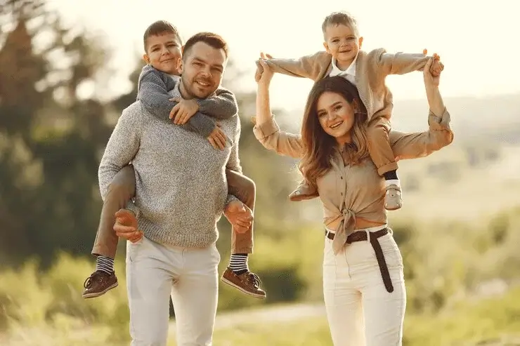 Family wearing coordinated neutral-toned outfits in beige, white, and earthy shades for a timeless and elegant portrait session.